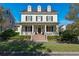 Two-story house with white columns, a front porch, and a manicured lawn at 5387 High Park Ln, Orlando, FL 32814