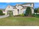 Two-story house with attractive landscaping and a paved driveway at 545 Kistler Cir, Clermont, FL 34715