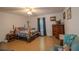 Bedroom with wood-framed bed, matching dresser, and ceiling fan at 595 S Morningside Dr, Eustis, FL 32726