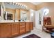 Double vanity bathroom with wood cabinets and a walk-in shower at 9033 Saint Andrews Way, Mount Dora, FL 32757