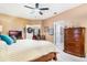 Main bedroom with a dresser and a view into the bathroom at 9033 Saint Andrews Way, Mount Dora, FL 32757