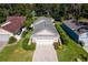 Aerial view of house with driveway and landscaping at 973 Belle Oak Dr, Leesburg, FL 34748