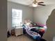 Charming bedroom with a full-size bed and a night stand at 9785 Pepper Tree Trl, Wildwood, FL 34785