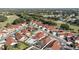 Aerial view of a community with red tile roofs, pools, and landscaped yards at 1003 Mi Tierra Way, The Villages, FL 32159