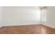 Empty bedroom with wood-look flooring and white walls at 1003 Mi Tierra Way, The Villages, FL 32159