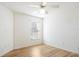 Empty bedroom with wood-look flooring, white walls, and a ceiling fan at 1003 Mi Tierra Way, The Villages, FL 32159