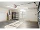 Garage interior with shelving, concrete flooring, and a window at 1003 Mi Tierra Way, The Villages, FL 32159