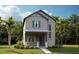 Two-story craftsman style home with teal accents and a manicured lawn at 10144 Pearson Ave, Orlando, FL 32827