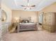 Main bedroom with tray ceiling, carpet, and matching bedroom set at 11075 Se 173Rd Pl, Summerfield, FL 34491