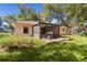 House back view, showcasing backyard patio, screened porch, and grill at 13591 Se 44Th Ter, Summerfield, FL 34491