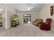 Relaxing living room with vaulted ceilings, ceiling fan, and sliding glass doors to patio at 13591 Se 44Th Ter, Summerfield, FL 34491