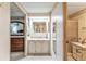 Clean bathroom with single sink vanity, shower/tub combo, and linen storage at 1435 Mohawk Cir, Tavares, FL 32778