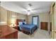 Bright bedroom with double bed, dresser, and ceiling fan at 1435 Mohawk Cir, Tavares, FL 32778