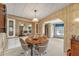 Round dining table with four chairs and built-in hutch at 1435 Mohawk Cir, Tavares, FL 32778