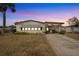 Front view of a single-wide manufactured home at dusk at 1435 Mohawk Cir, Tavares, FL 32778