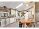 Another view of the kitchen with a breakfast bar and stainless appliances at 1435 Mohawk Cir, Tavares, FL 32778