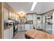 Galley kitchen with stainless steel appliances and light wood cabinets at 1435 Mohawk Cir, Tavares, FL 32778