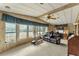 Living room with home gym equipment and lots of natural light at 1435 Mohawk Cir, Tavares, FL 32778