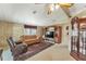 Spacious living room with a brown leather sofa and recliner at 1435 Mohawk Cir, Tavares, FL 32778