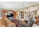 Spacious living room with leather furniture and a large TV at 1435 Mohawk Cir, Tavares, FL 32778