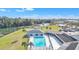 Community pool and clubhouse with lake view at 1435 Mohawk Cir, Tavares, FL 32778