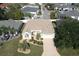Single-Gathering home with a light brown roof and landscaped yard at 1443 Greenville Way, The Villages, FL 32162
