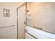 Clean bathroom with a shower and grab bars at 1443 Greenville Way, The Villages, FL 32162