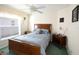 Charming bedroom with wood furniture and soft blue bedding at 1443 Greenville Way, The Villages, FL 32162
