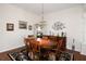 Bright dining room with wood table and chairs, hardwood floors, and decorative art at 1443 Greenville Way, The Villages, FL 32162