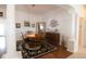 Bright dining room with wood table and chairs, hardwood floors, and decorative art at 1443 Greenville Way, The Villages, FL 32162