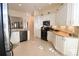 Bright kitchen with white cabinets, granite countertops, and tile floors at 1443 Greenville Way, The Villages, FL 32162