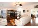 Spacious living room with hardwood floors, comfortable seating, and large windows at 1443 Greenville Way, The Villages, FL 32162