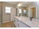 Double vanity bathroom with modern fixtures and a glass shower at 16436 Hamlin View St, Winter Garden, FL 34787