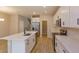 Modern kitchen with white cabinets, quartz countertops, and island at 16436 Hamlin View St, Winter Garden, FL 34787