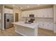 Modern kitchen with white cabinets, quartz countertops, and island at 16436 Hamlin View St, Winter Garden, FL 34787