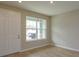 Simple living room with large window and door leading to exterior at 16436 Hamlin View St, Winter Garden, FL 34787