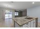 Kitchen island with granite countertops overlooks Gathering room at 1724 Point O Woods Ct, Mount Dora, FL 32757