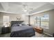 Main bedroom with large window and ceiling fan at 1730 Augustine Dr, The Villages, FL 32159