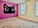 Bedroom with purple accent wall and carpet at 209 Hyacinth Ct, Kissimmee, FL 34759