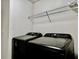 Convenient laundry room with washer, dryer, and shelving at 209 Hyacinth Ct, Kissimmee, FL 34759
