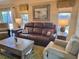 Comfortable living room featuring leather furniture and large windows at 2372 Arbordale Ave, The Villages, FL 32162