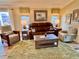 Living room with leather couches, coffee table and hardwood floors at 2372 Arbordale Ave, The Villages, FL 32162