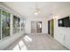Sunroom with tile floor, ceiling fan, and view of backyard at 2514 Raintree Dr, The Villages, FL 32162