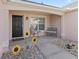 Covered porch with seating and sunflowers near the entryway at 3000 Saint Michael Ln, The Villages, FL 32162