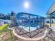 Screened pool and patio with landscaped backyard at 316 Amanda Ln, Leesburg, FL 34748