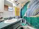 Clean bathroom with teal shower curtain and updated vanity at 316 Amanda Ln, Leesburg, FL 34748