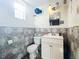 Small bathroom with toilet, vanity, and geometric tile at 316 Amanda Ln, Leesburg, FL 34748