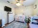 Bedroom with crib, dresser, and wall decor at 316 Amanda Ln, Leesburg, FL 34748