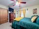 Serene bedroom with teal bedding and a large dresser at 316 Amanda Ln, Leesburg, FL 34748