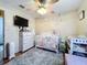 Adorable Bedroom featuring a crib, dresser, and neutral color scheme at 316 Amanda Ln, Leesburg, FL 34748